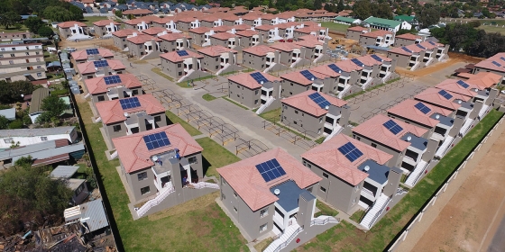 A shot above an estate with solar panels on the roofs.