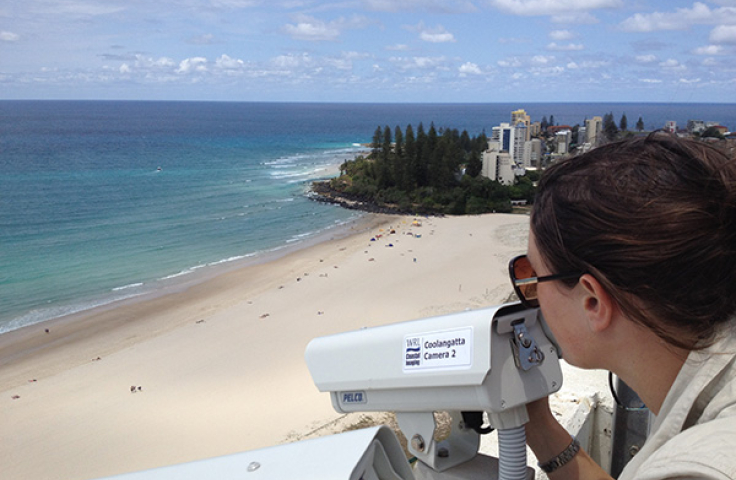 A person looking through a camera above Manly beach