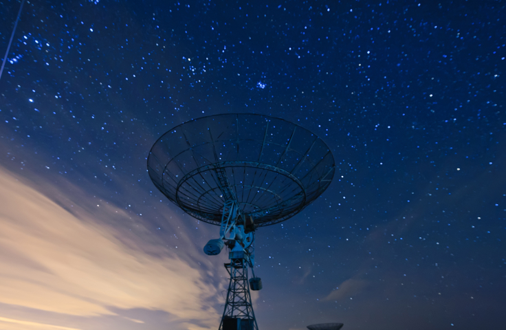 satellite dish under a starry sky