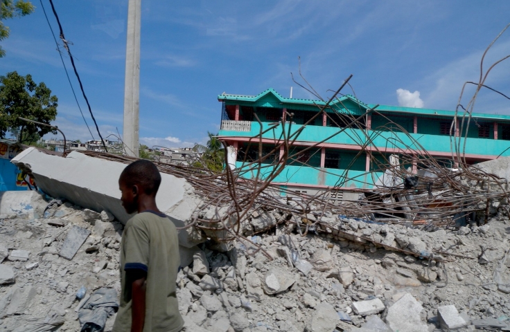 An image of Haiti following the earthquake. In the foreground is rubble from toppled structures.