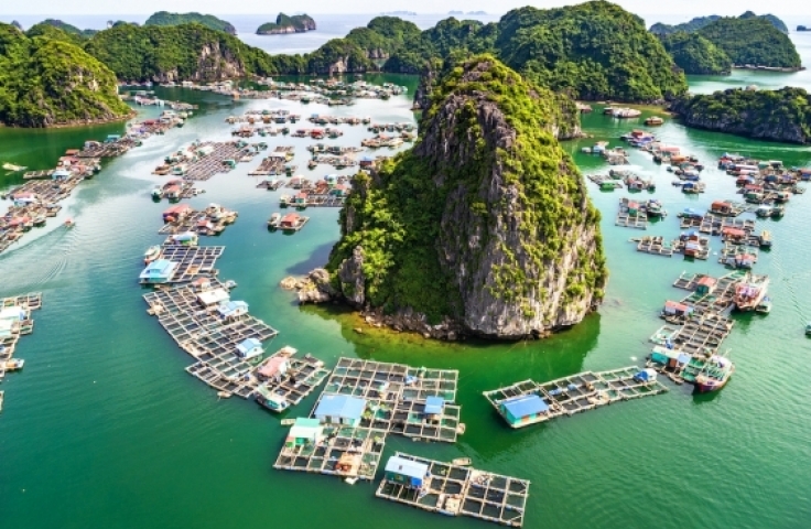 This image shows a floating fishing village in Vietnam taken from aerial view.